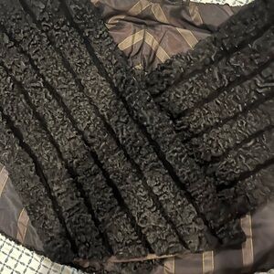 Vintage black Persian lamb fur coat known for tightly curled wavy texture